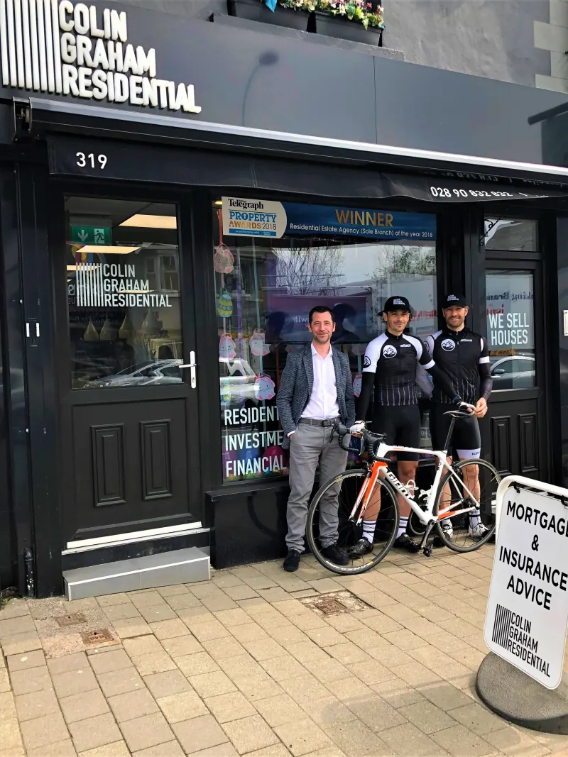 Kenny Wilson and Team Elevation Coaching cyclists with Colin Graham outside the Colin Graham Residential office in Newtownabbey